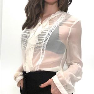 Ivory sheer blouse with ruffle detail.